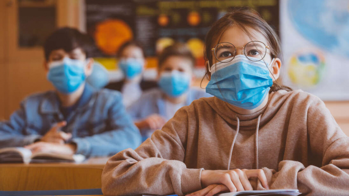 Teenage girl wearing N95 face mask at school